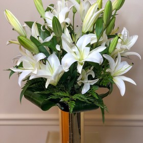 White lilies in a gold vase